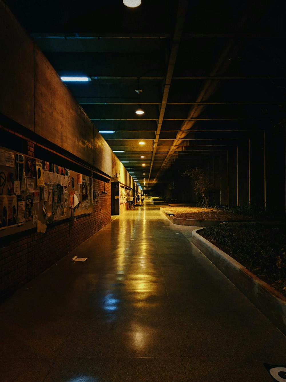 brown and black concrete tunnel with light