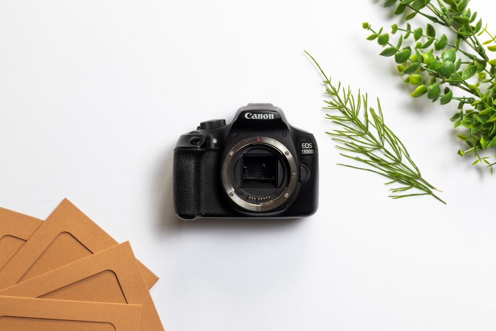 black nikon dslr camera on white table