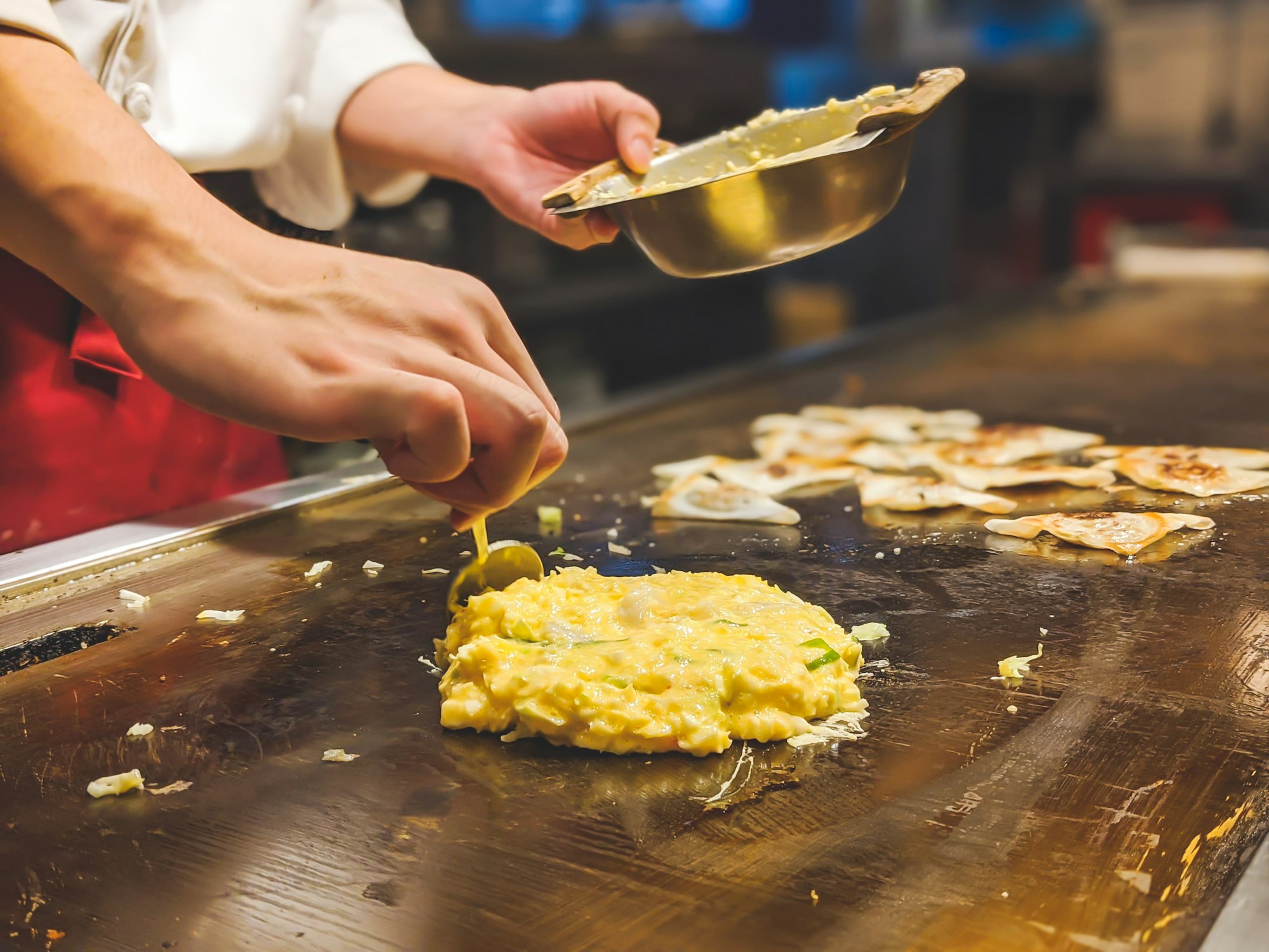 Seafood omelette teppanyaki known as Okonomiyaki made right in front of us in Osaka, Japan. 