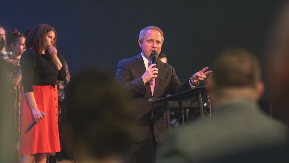 man in black suit singing