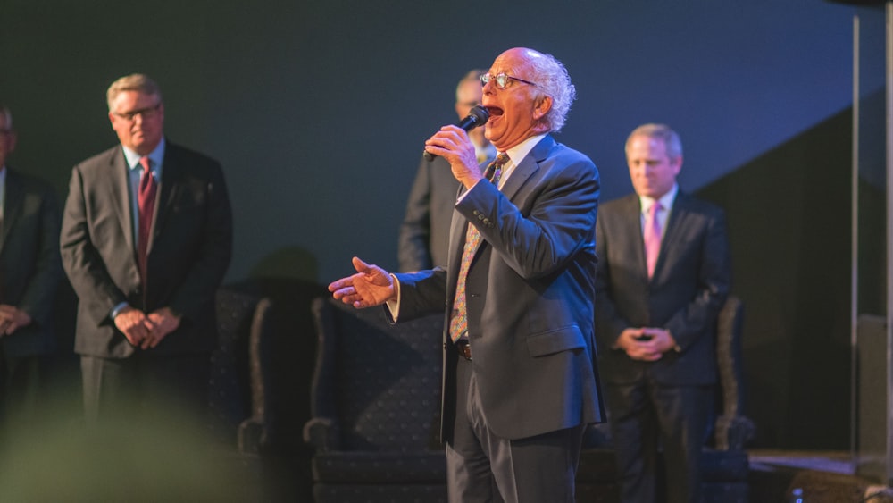 man in black suit singing