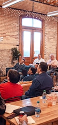 people sitting on chair in front of table