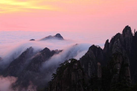 black and white mountains under white clouds during daytime in Huangshan China