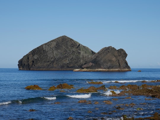 gray rock formation on sea water during daytime in Azores Portugal