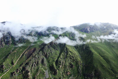 green mountain covered with clouds
