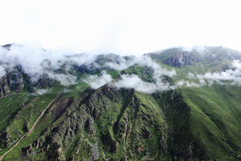 green mountain covered with clouds