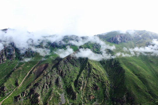 green mountain covered with clouds in Ollantaytambo Peru