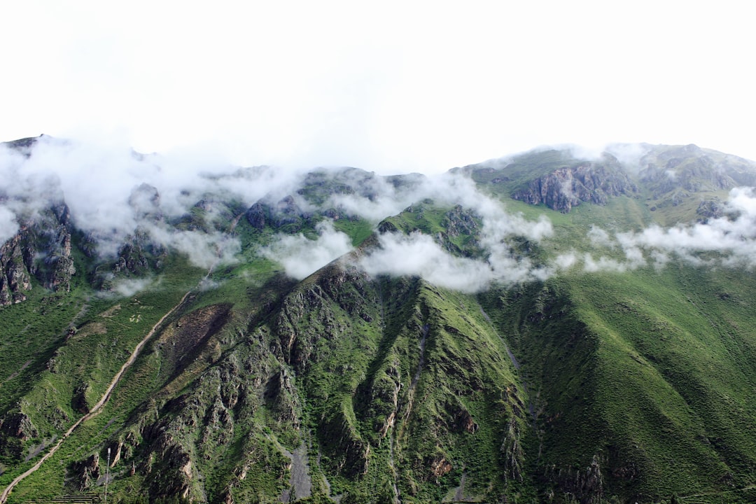 green mountain covered with clouds,