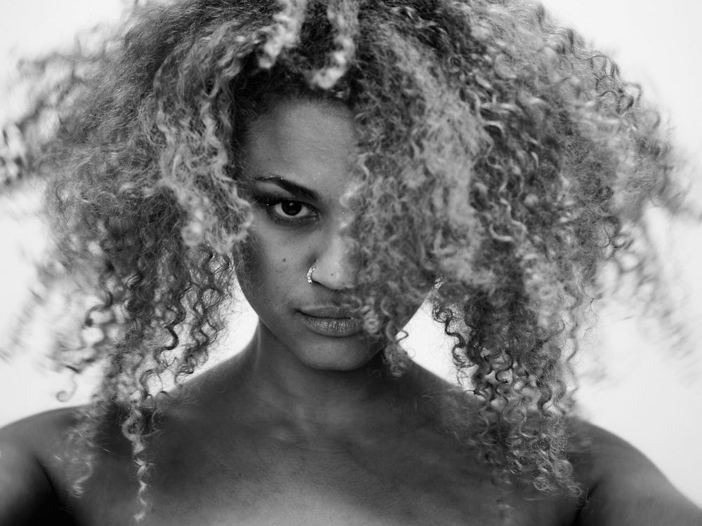 woman with curly hair wearing silver necklace