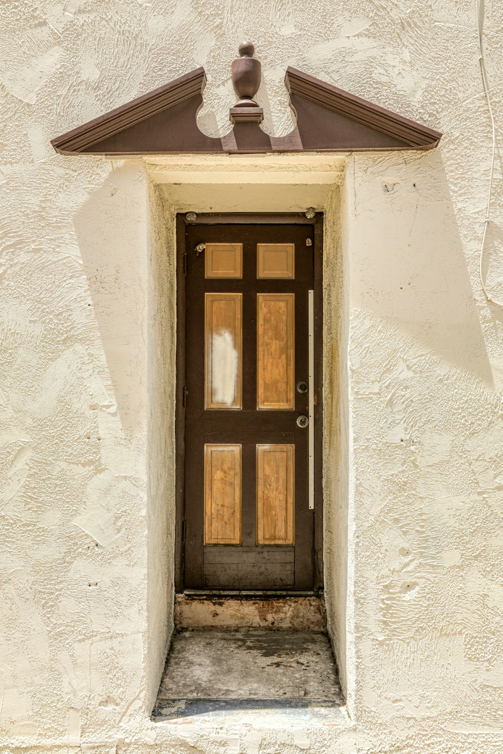 brown wooden window on white concrete wall