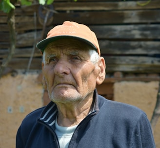 man in black zip up jacket and brown hat