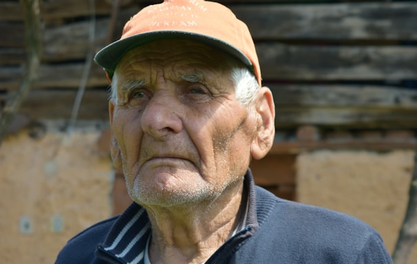 man in black zip up jacket and brown hat