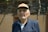 man in black zip up jacket wearing brown hat