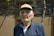 man in black zip up jacket wearing brown hat