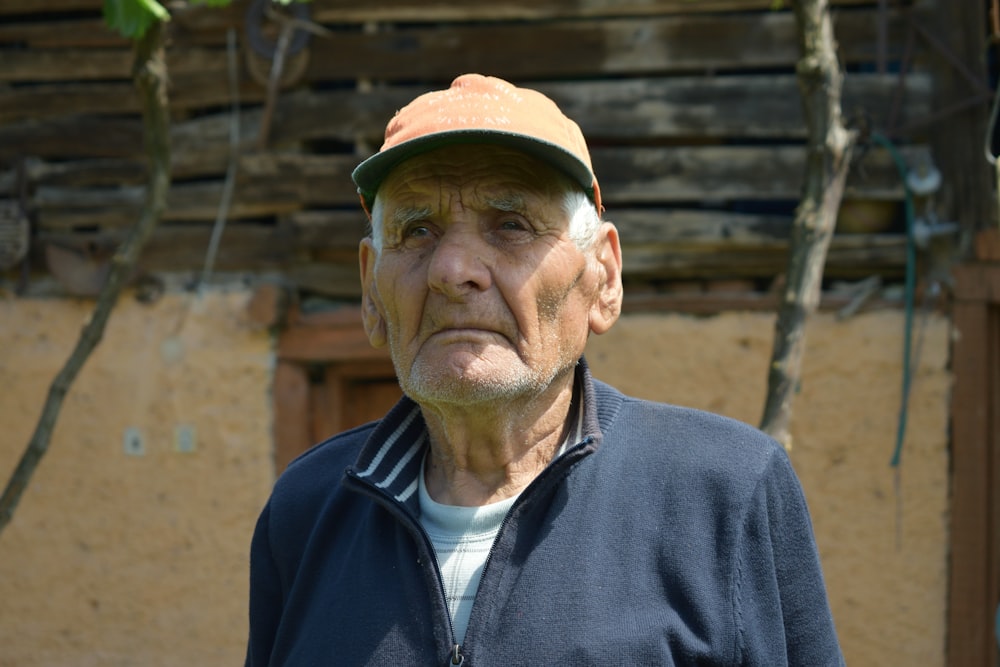 man in black zip up jacket wearing brown hat