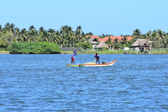 people riding on yellow kayak on body of water during daytime in Pondicherry India