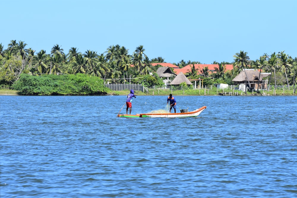 people riding on yellow kayak on body of water during daytime