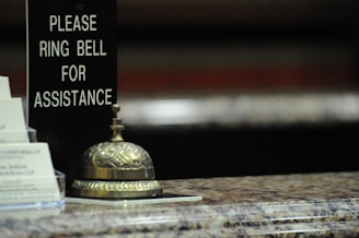 gold bell on brown wooden table