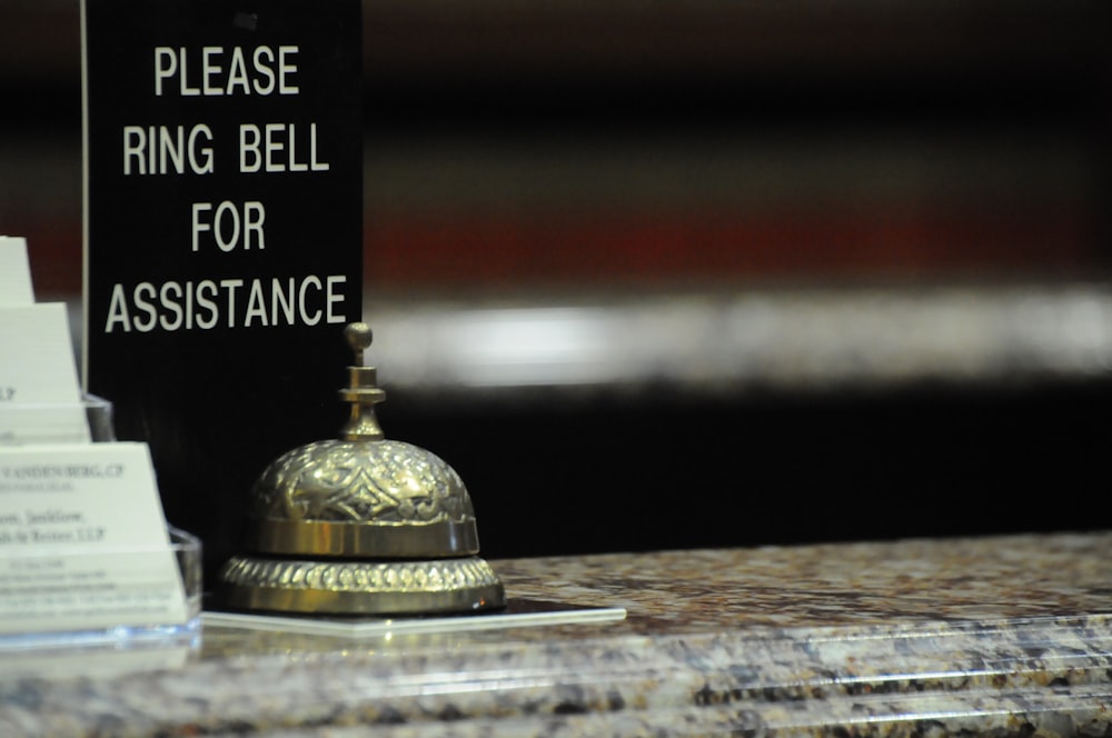 gold bell on brown wooden table