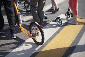 A group of diverse commuters waiting at a city crosswalk, each with a different model of Tuya Smart electric scooter.