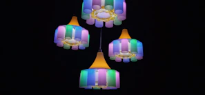 A cluster of colorful glass lamps glowing gently in a stylish bedroom setting