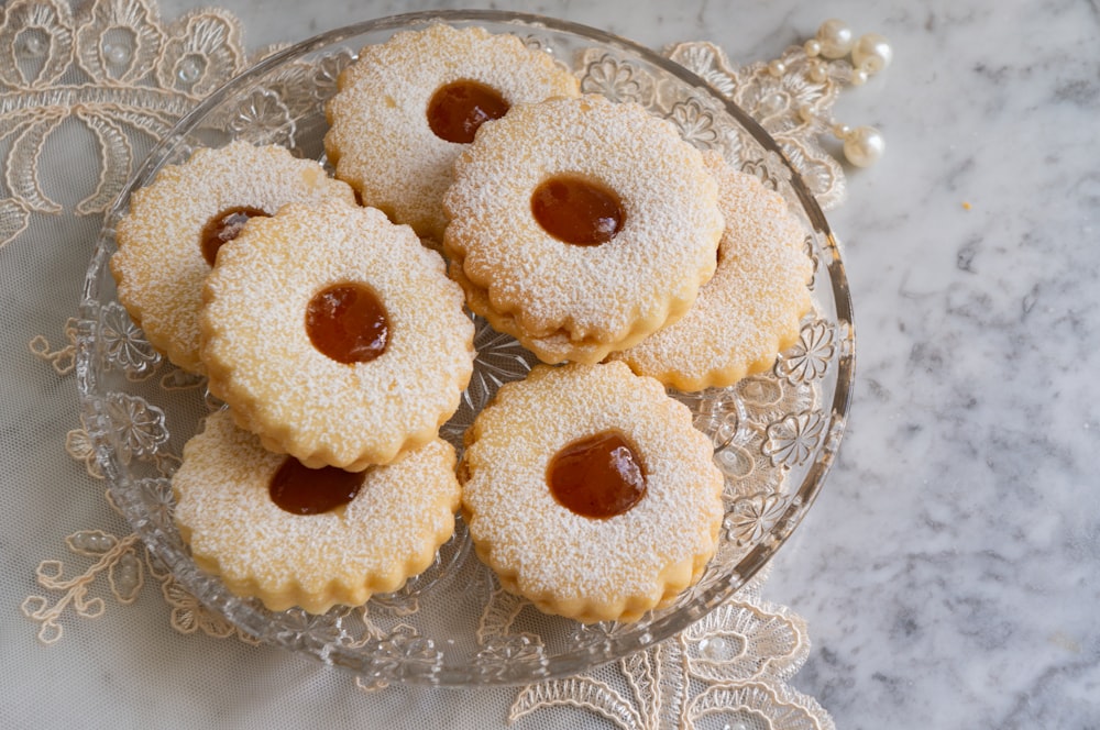 three brown cupcakes on clear glass plate