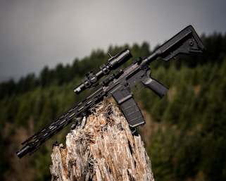 black assault rifle on brown wood