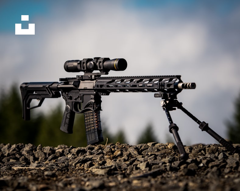 Black rifle with scope on brown soil photo – Free Gun Image on Unsplash