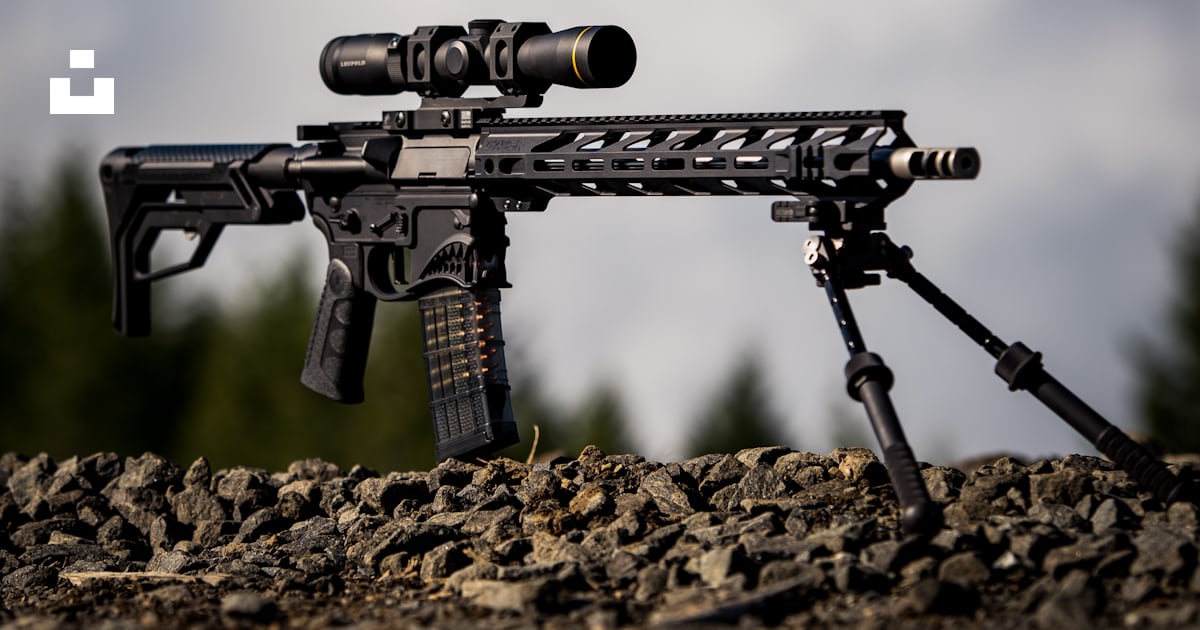 Black rifle with scope on brown soil photo – Free Gun Image on Unsplash
