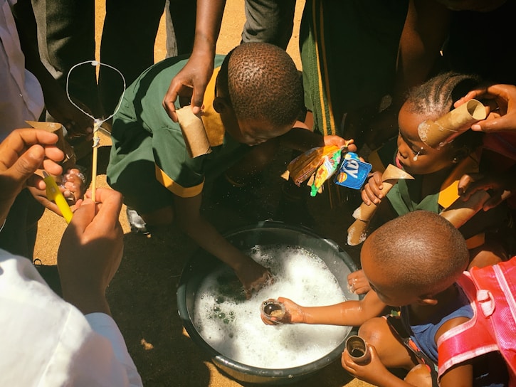 A group of children engaged in a hands-on science experiment outdoors.