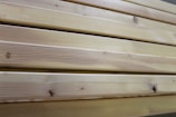 Close-up of raw wood panels stacked neatly.