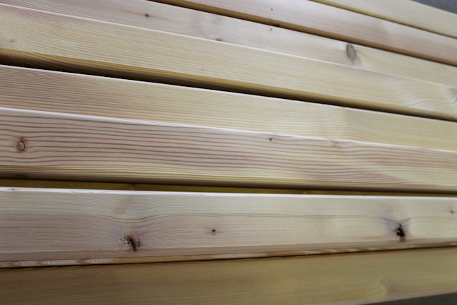 Close-up of freshly cut wooden planks stacked neatly in a warehouse.