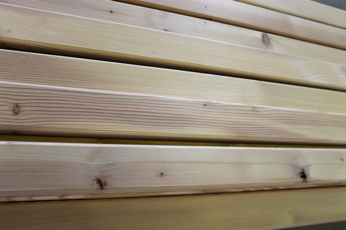 Close-up of natural oak timber planks stacked neatly in a workshop.