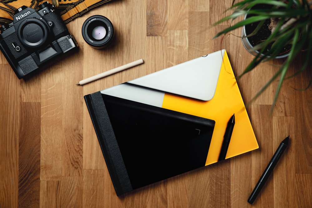 black ipad on yellow folder