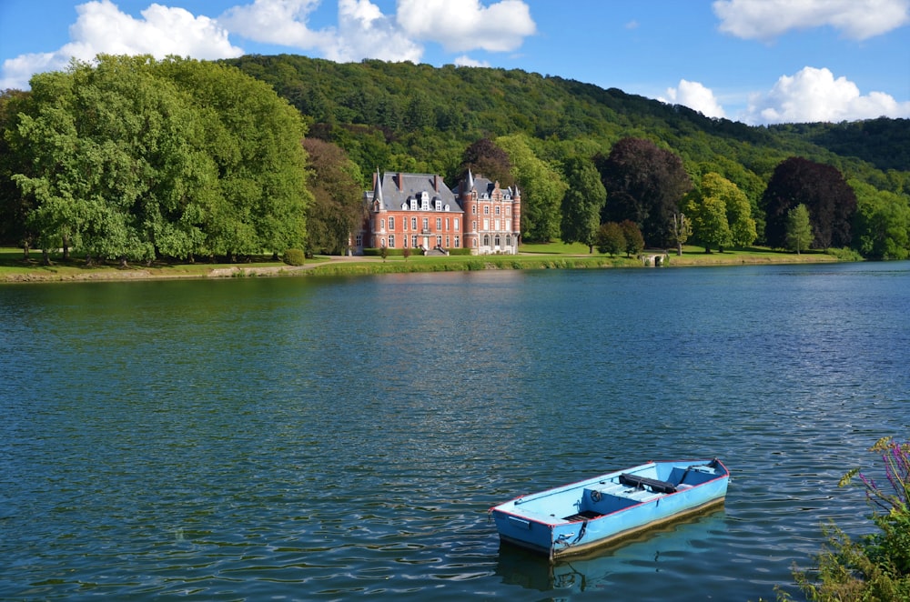 white and blue boat on lake during daytime