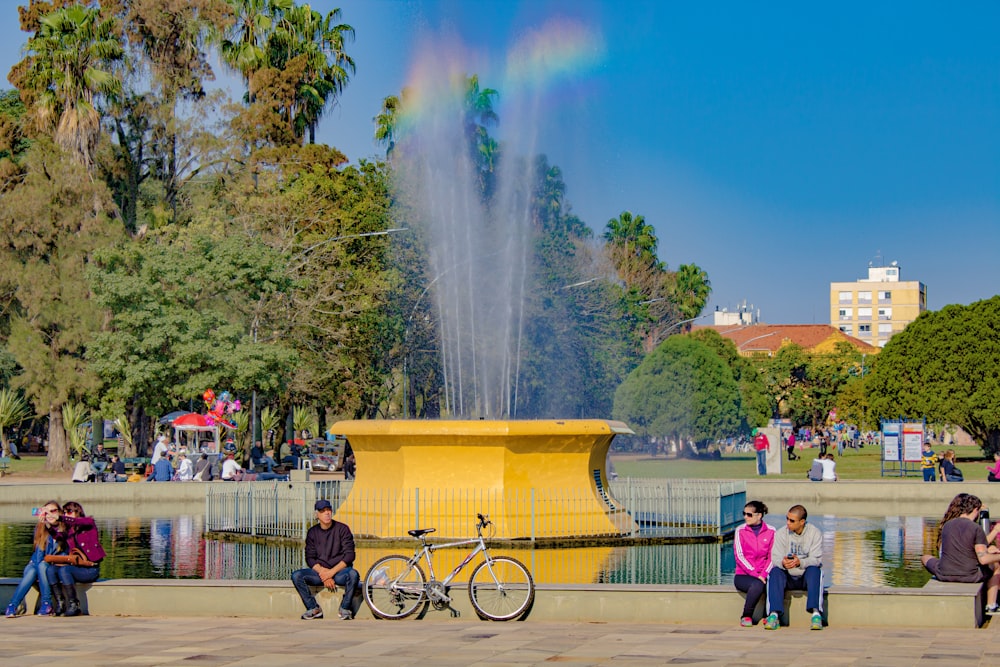 people standing near fountain during daytime