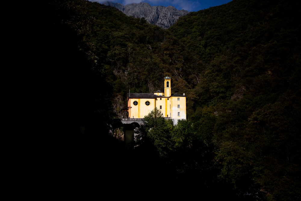 white concrete building on mountain