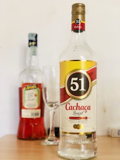 clear glass bottle with red liquid