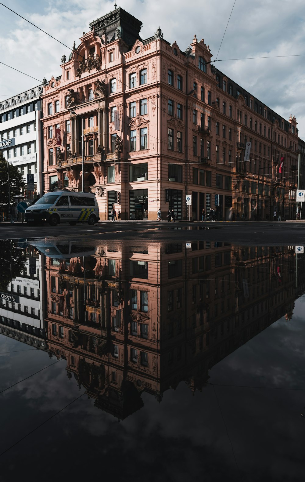 cars parked beside brown building during night time