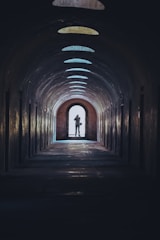 person walking on tunnel during daytime
