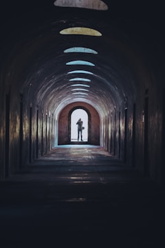person walking on tunnel during daytime