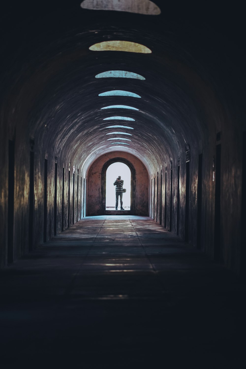 person walking on tunnel during daytime