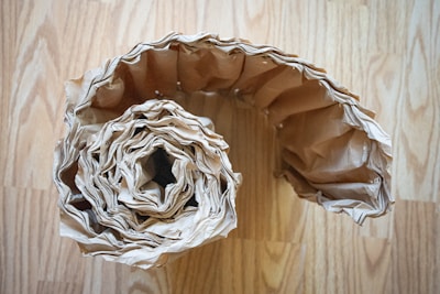white and black textile on brown wooden table