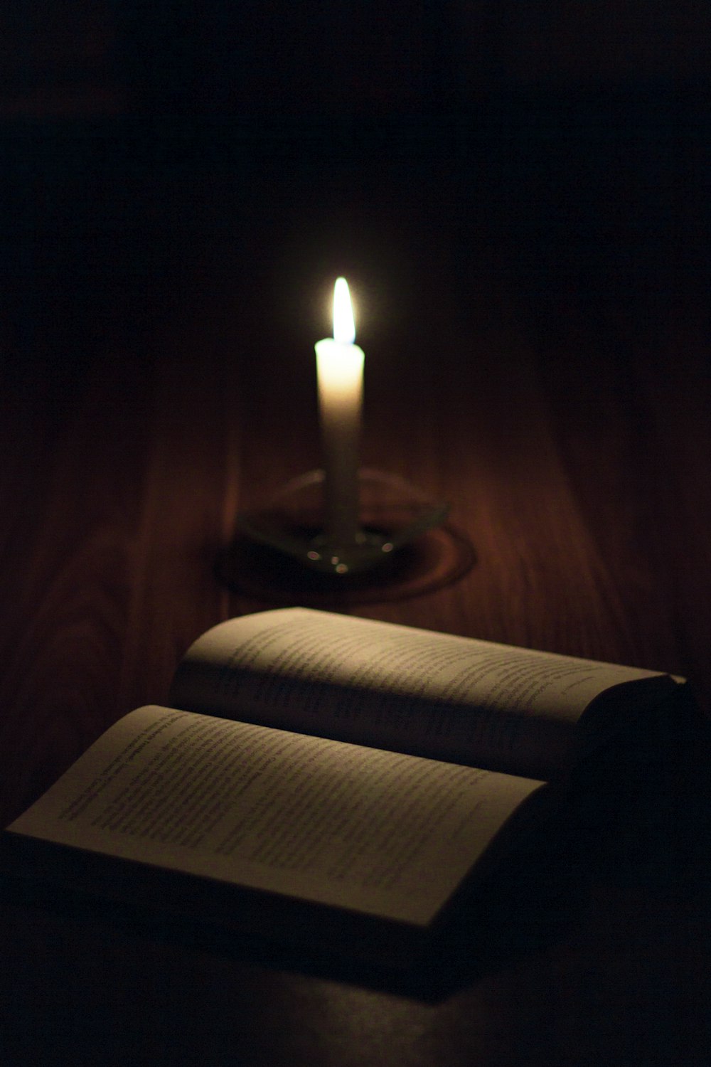 white pillar candle on brown wooden candle holder