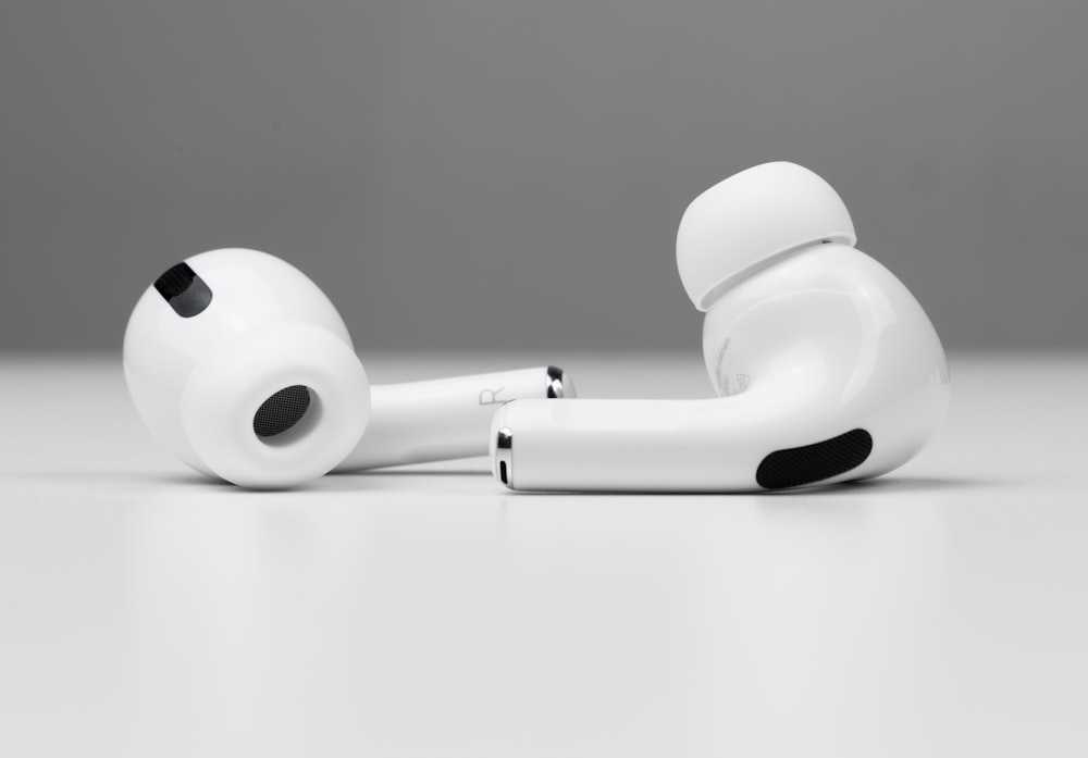 white apple earpods on white surface