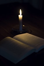 white candle on white book page