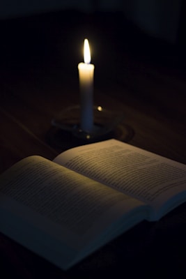 white candle on white book page