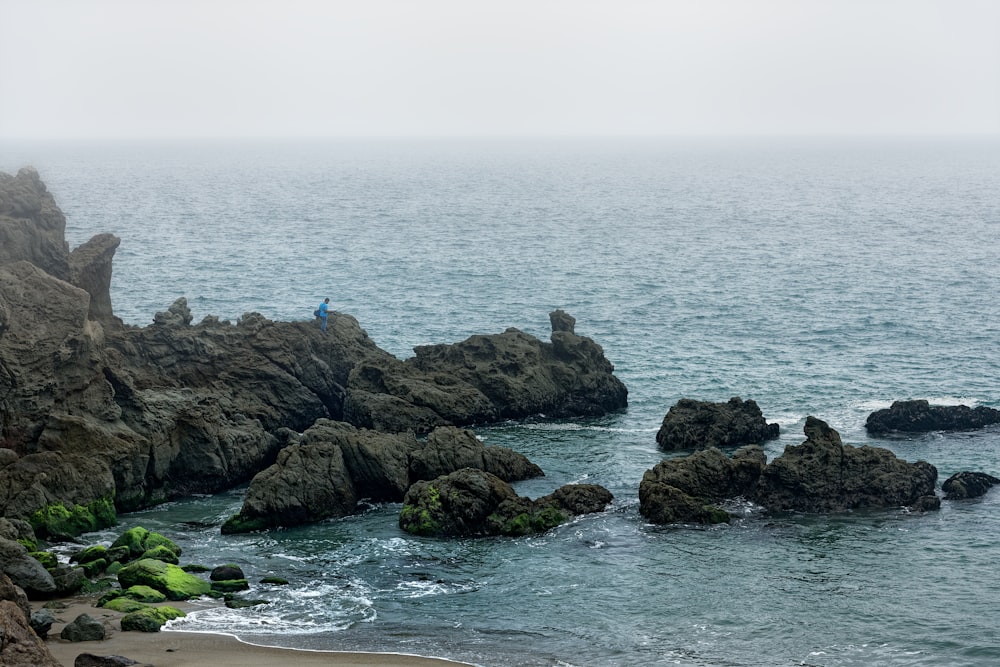 brown rock formation on sea during daytime