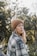 woman in brown knit cap and plaid shirt