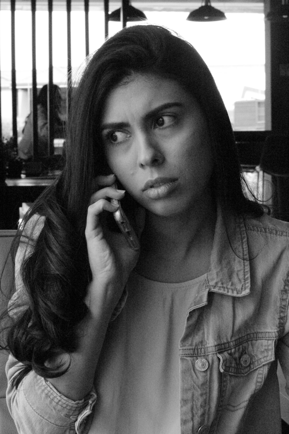 woman in gray long sleeve shirt holding phone